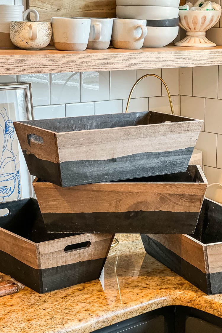 Wiping bins down for the pantry makeover