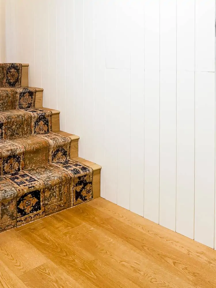 vintage rug on stairs to basement 