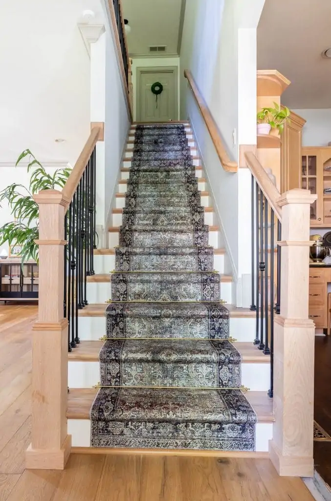 patterned carpet on stairs with stair rod spindles 