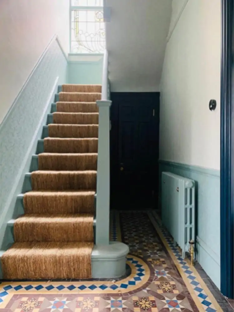 jute stair rugs on staircase with patterned tile below stairs