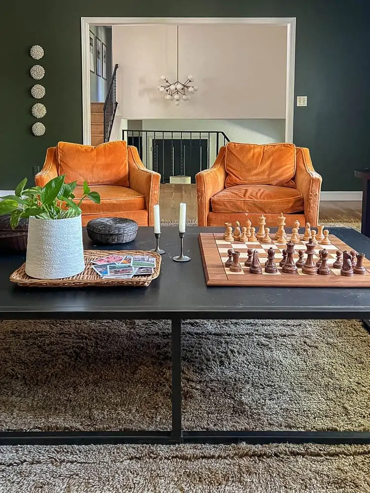 modern green living room with orange chairs