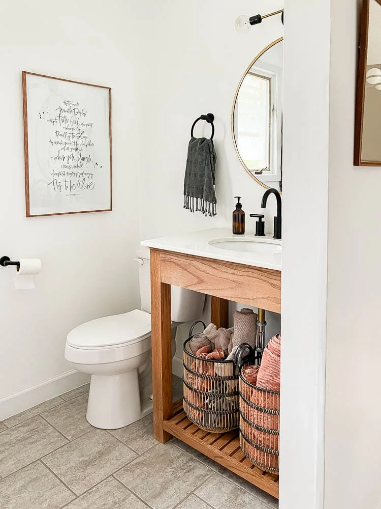 small bathroom with wood vanity and minimal accents