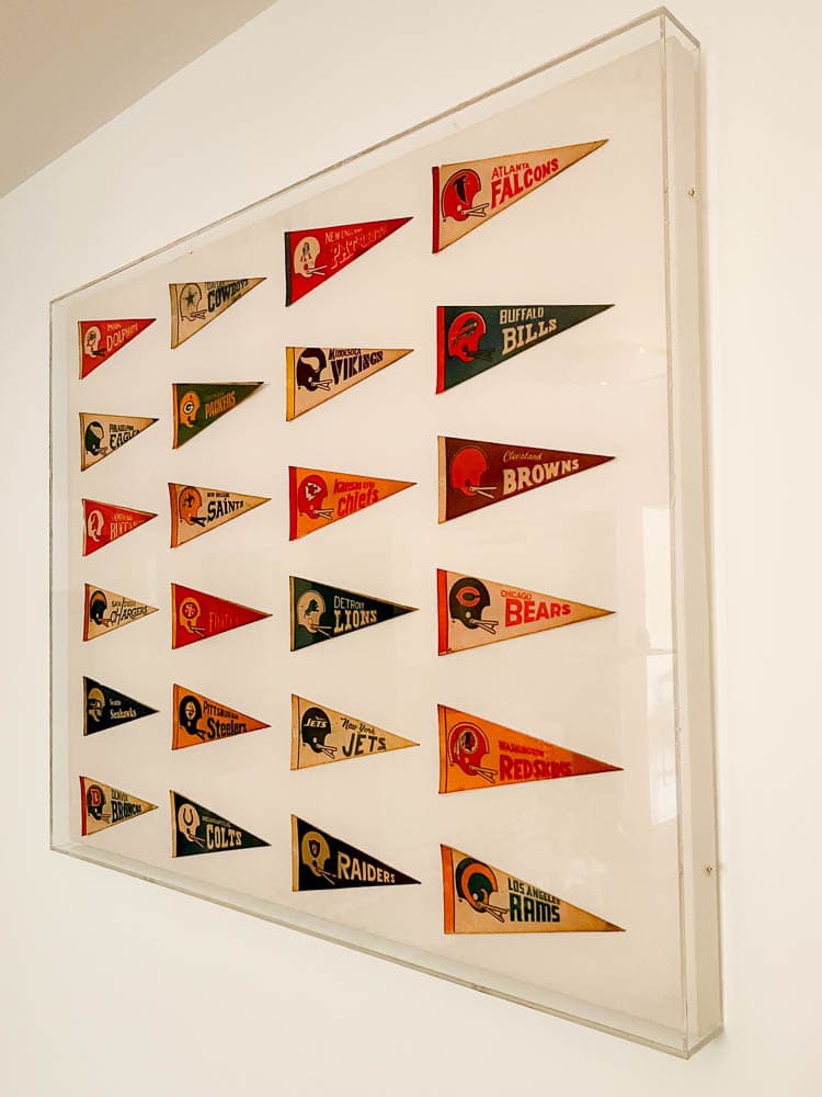 vintage pennants hung on canvas with an acrylic box frame over