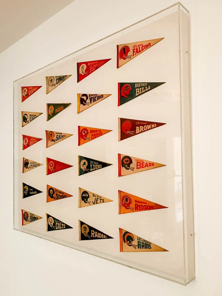 vintage pennants hung on canvas with an acrylic box frame over