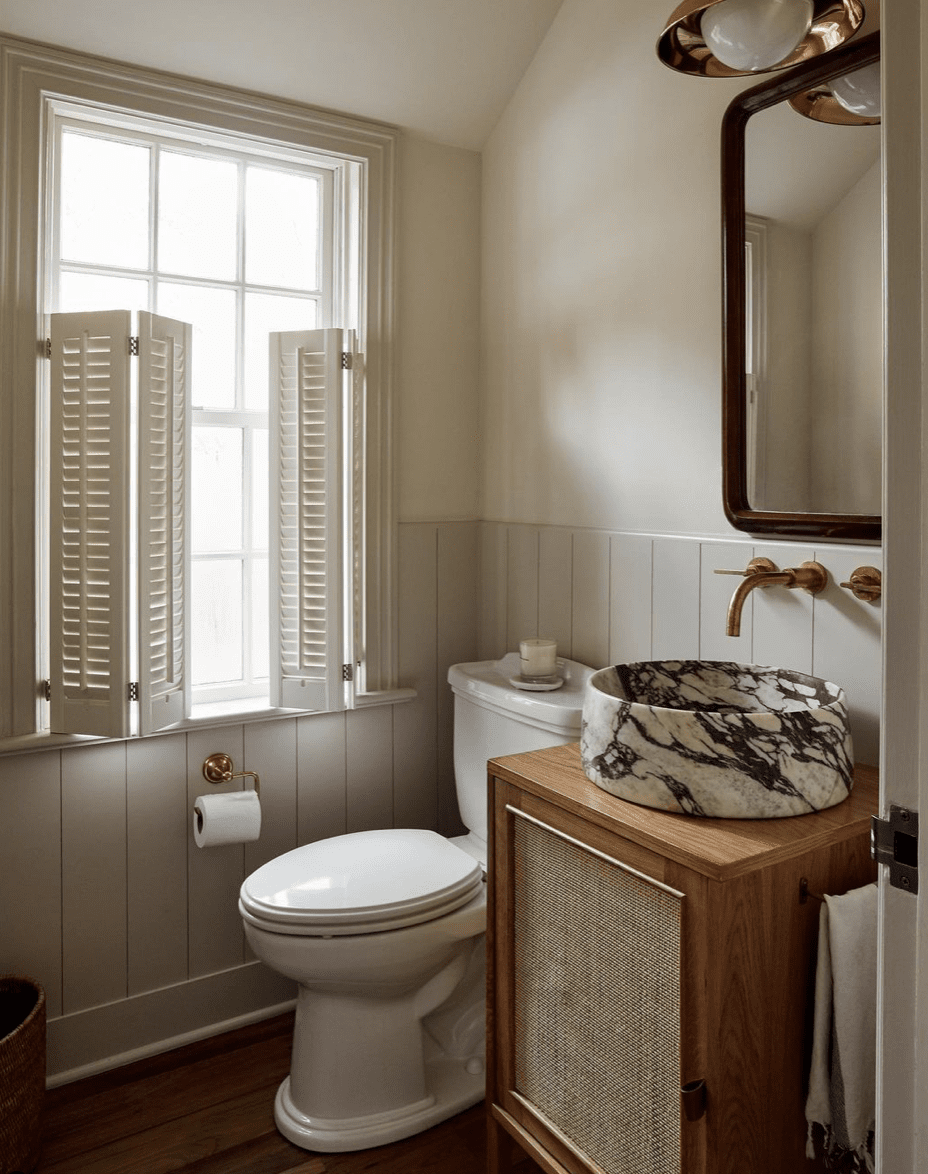 Minimalist bathroom with wood vanity and marble sink 