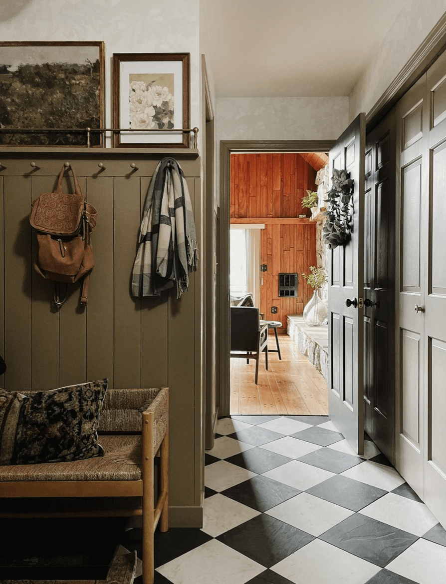 Shelf about shiplap wainscoting painted green with peg hooks