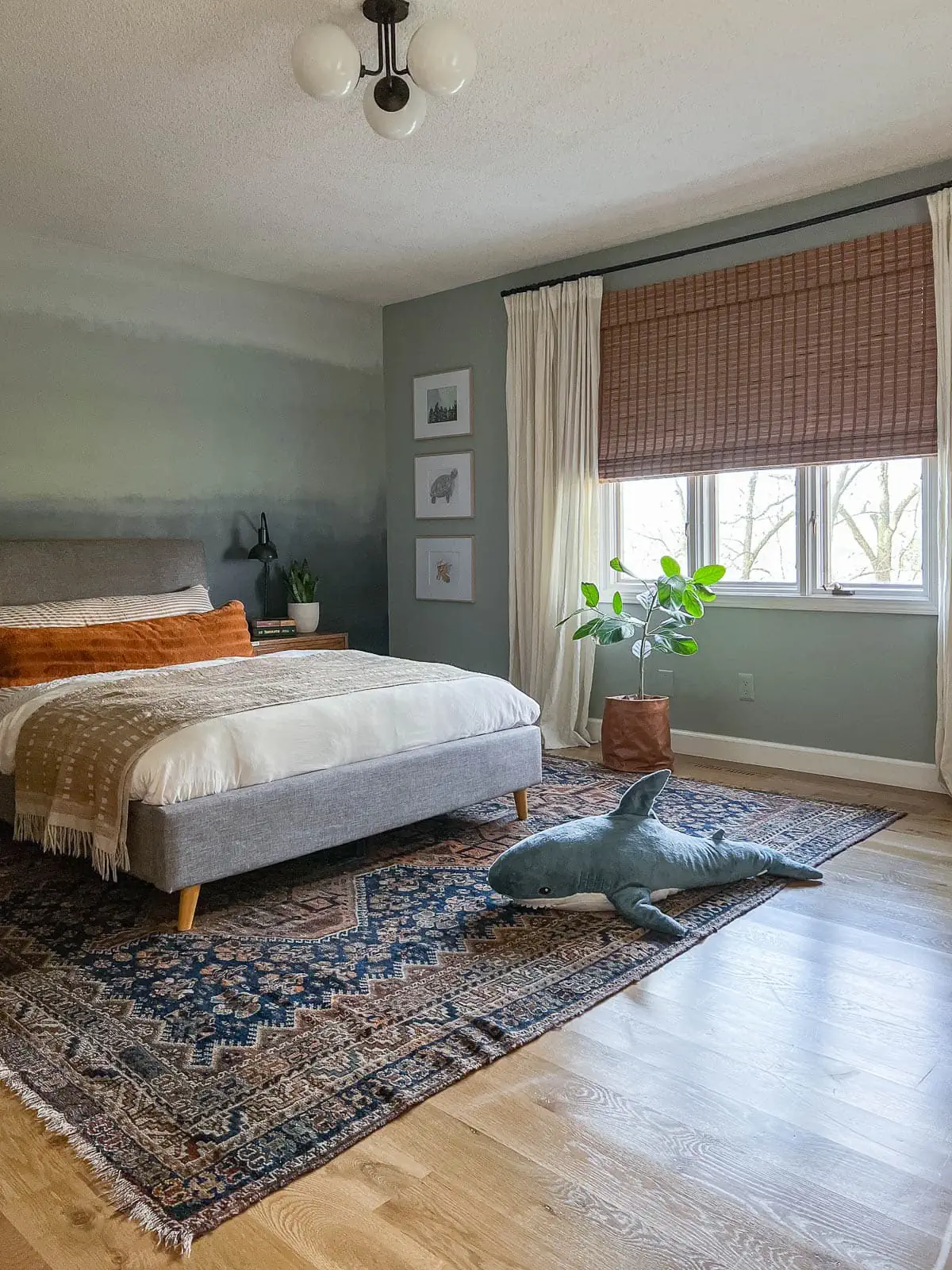 Ombre painted wall in bedroom with light blue gray paint