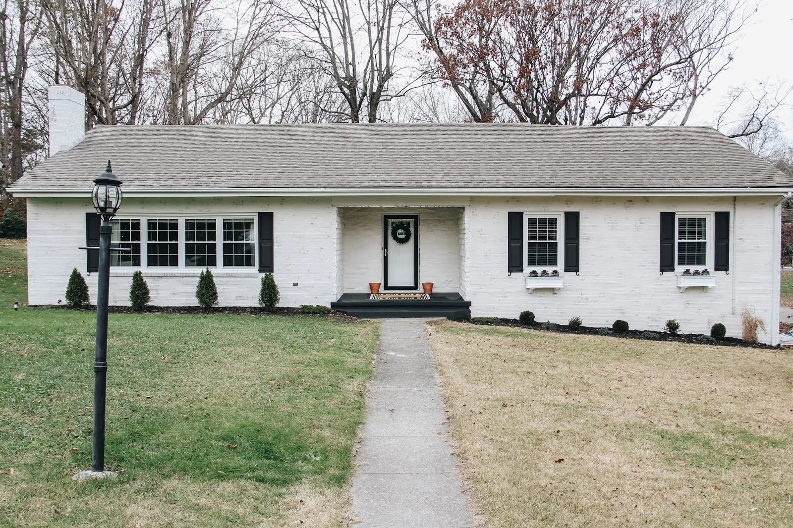 lime washed White House with black shutters 