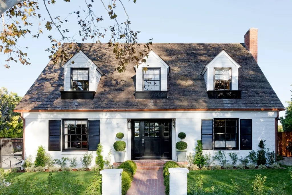 White brick house black shutters