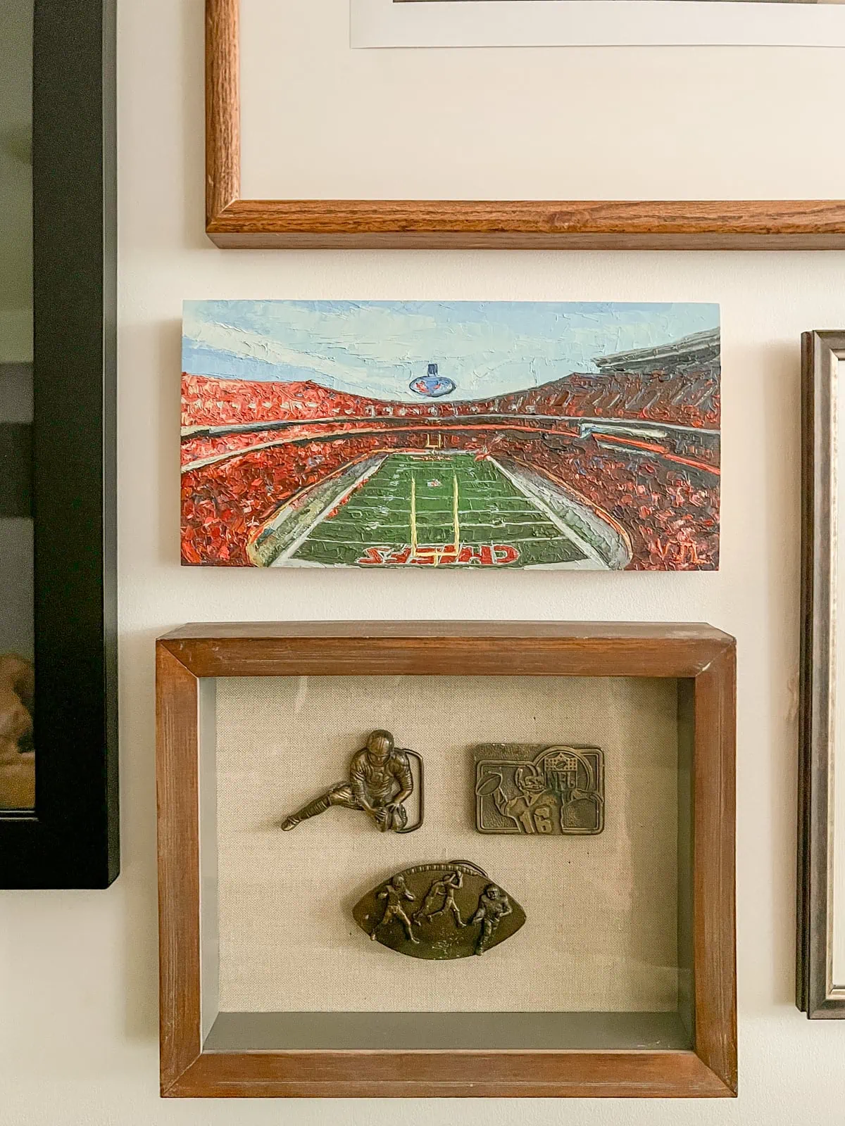 brass belt buckles as sports decor on the wall in the basement 