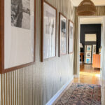 brown and white striped hallway with travel photo frames
