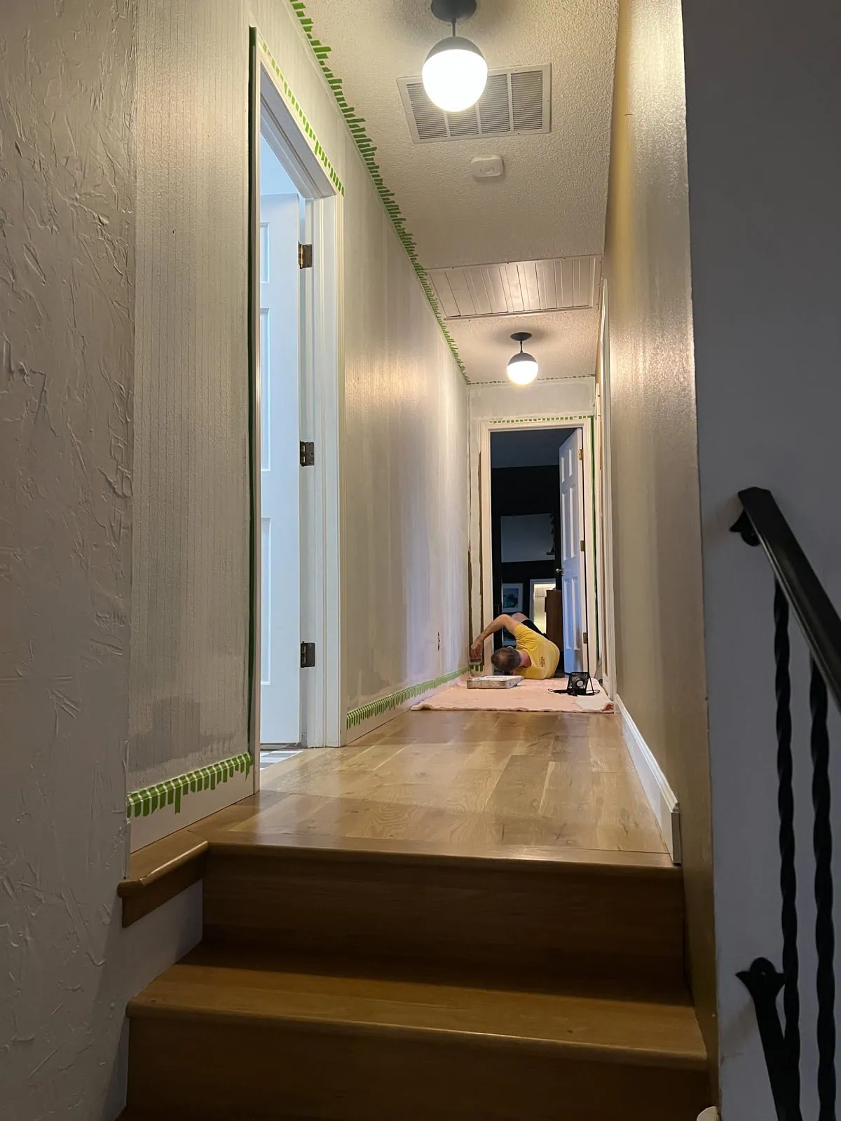 rolling over the painters tape in the striped hallway
