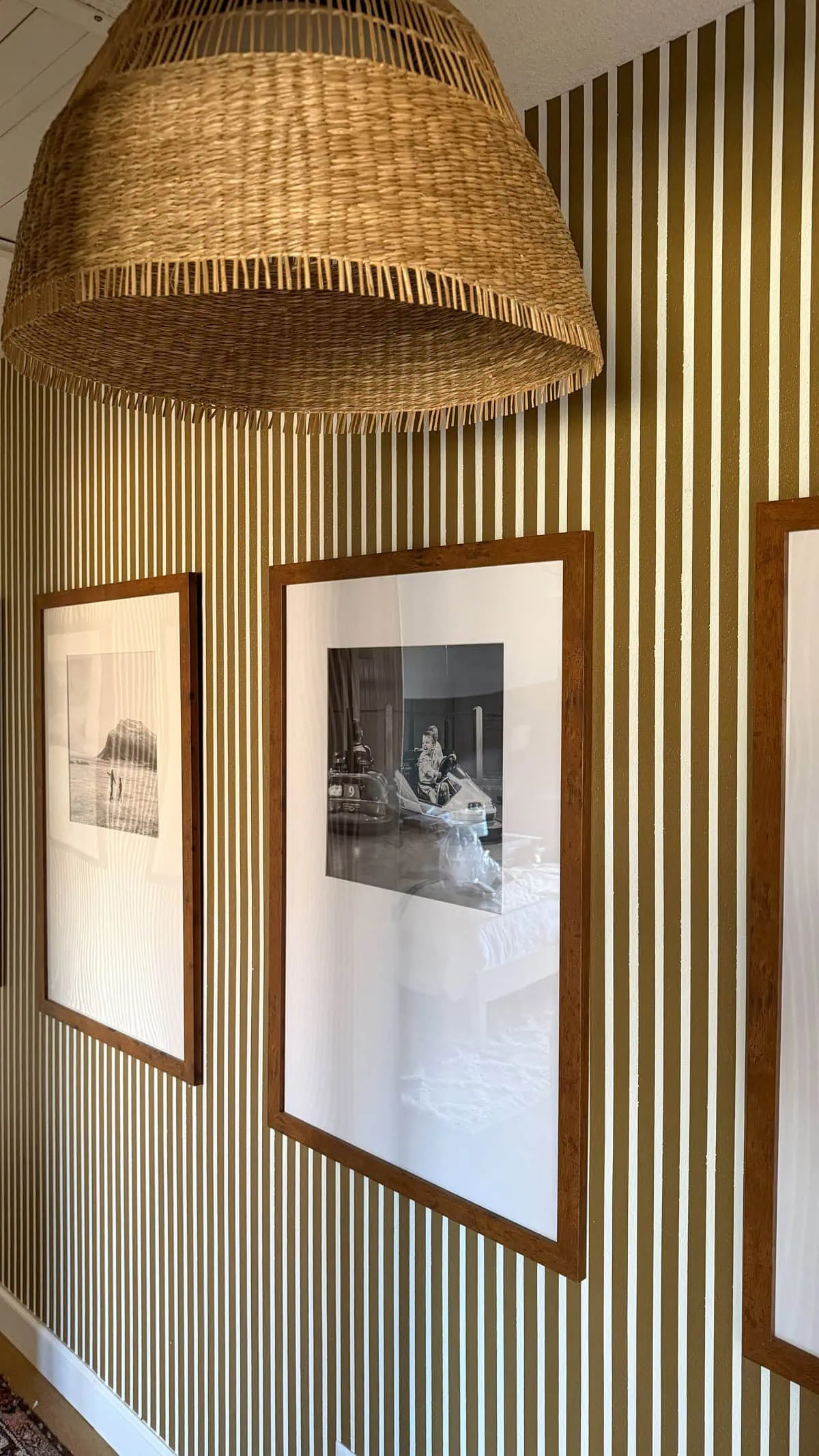brown and white stripes in hallway with gallery wall
