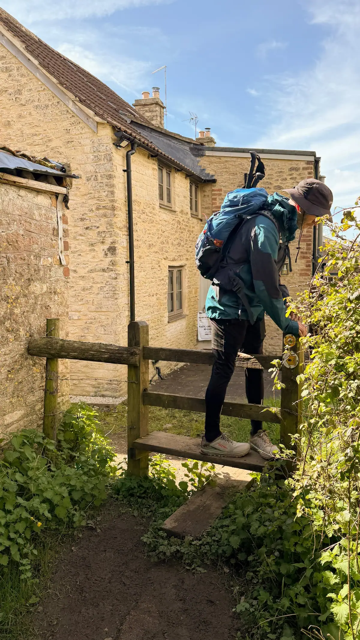 trail marking on post with a fence climb
