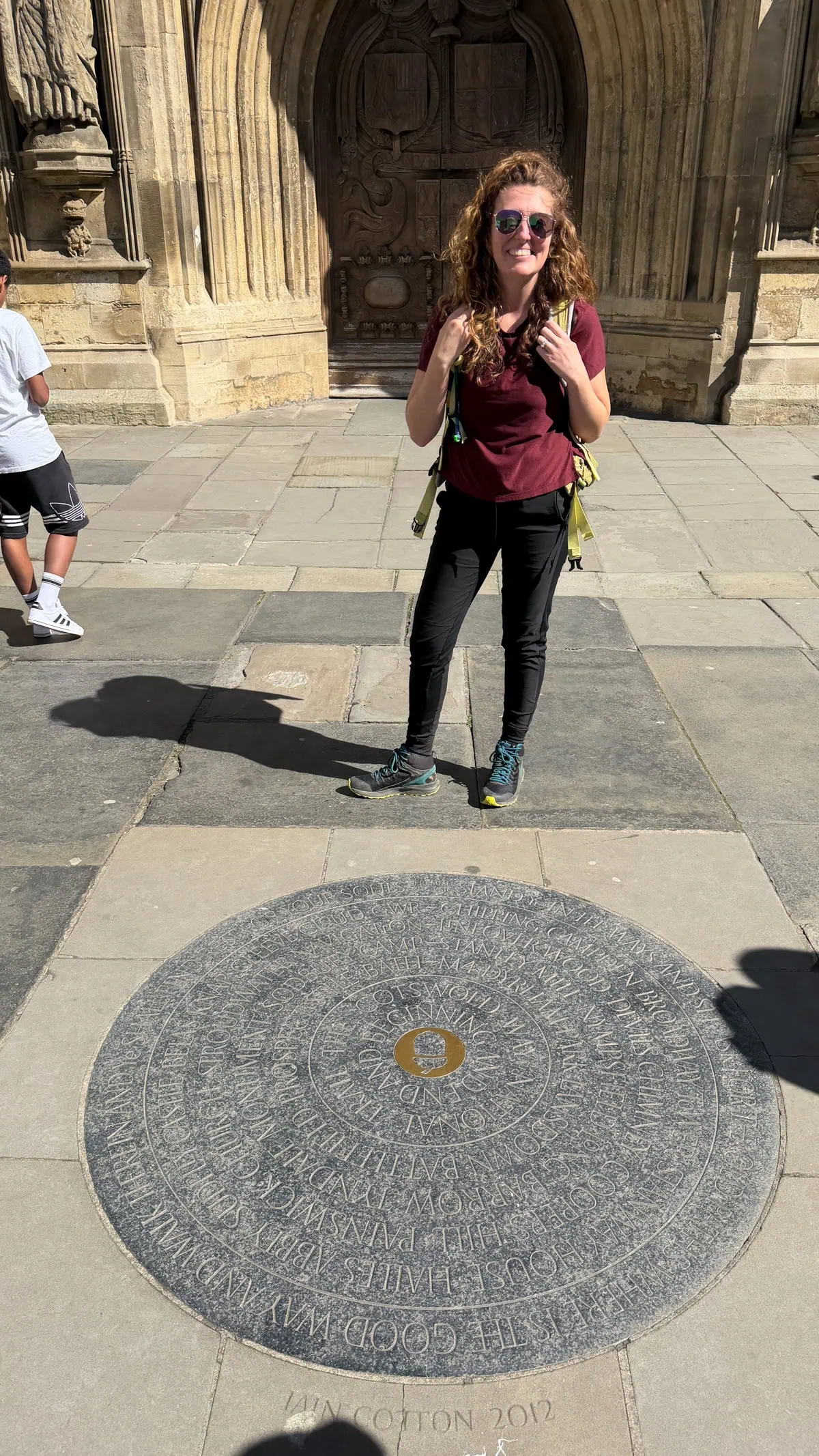 marker for the Cotswold Way in Bath England right in front of a church.